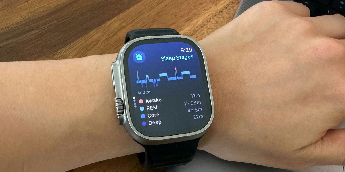 Apple Watch Ultra 2 on wrist with wooden background