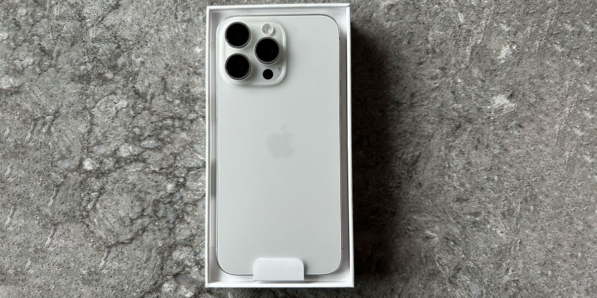 iPhone Pro Max in box on gray background