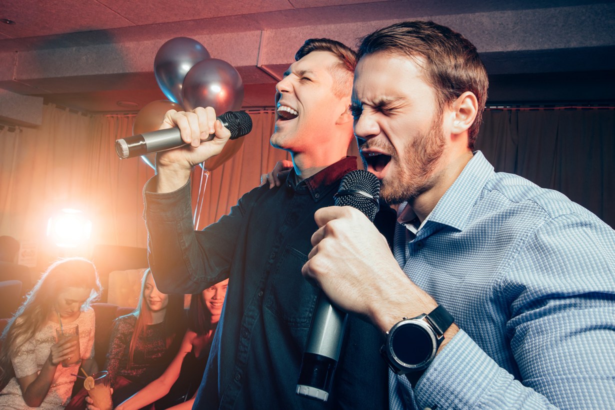 two men singing karaoke