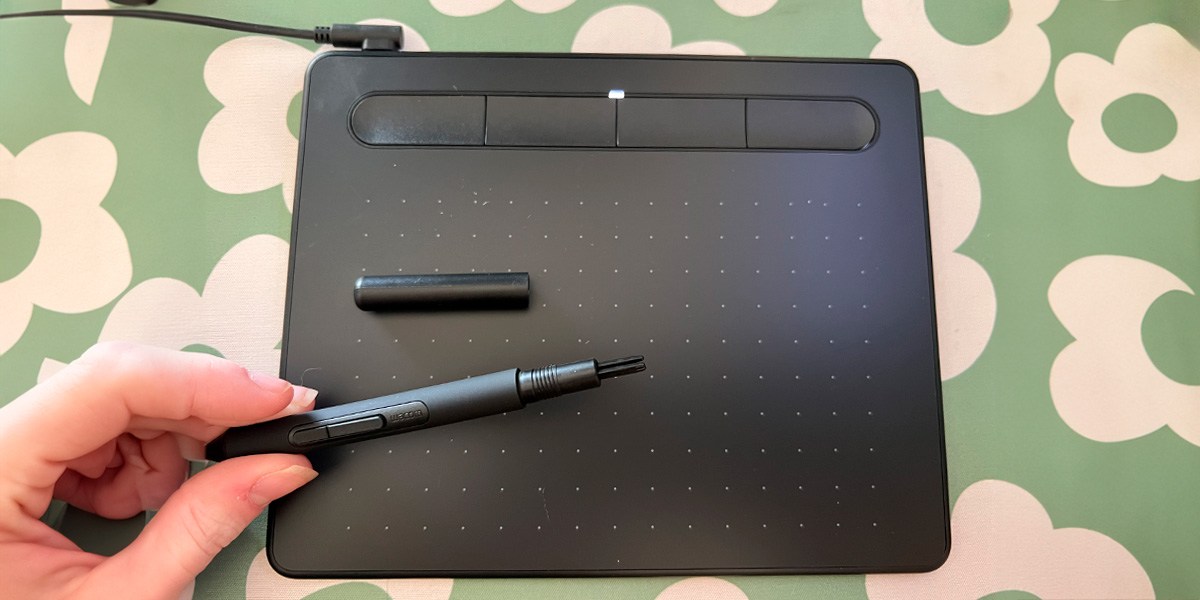 Wacom Intuos S with pen on green and white background Wacom Intuos S with pen on green and white background