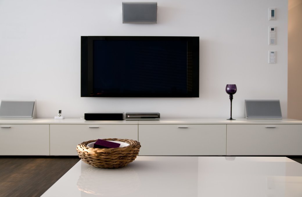 Flat screen TV and soundbar mounted on wall