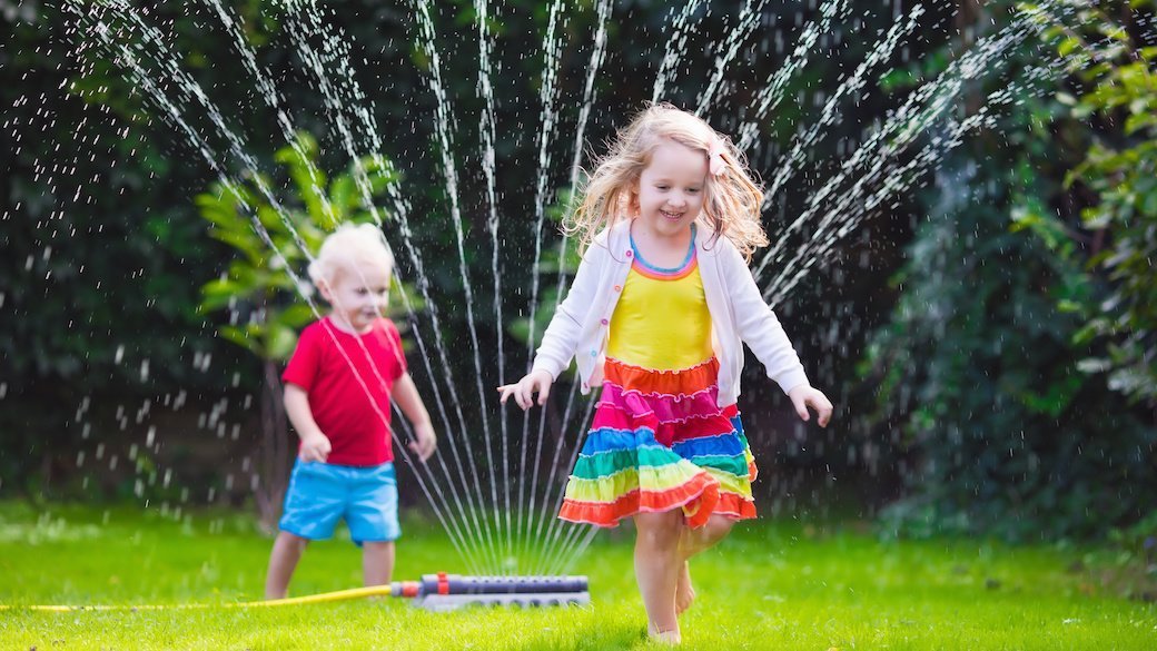 kids playing in sprinkler