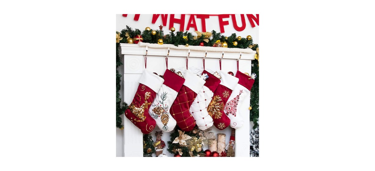 3 red Christmas stockings and 3 white Christmas stockings hanging up
