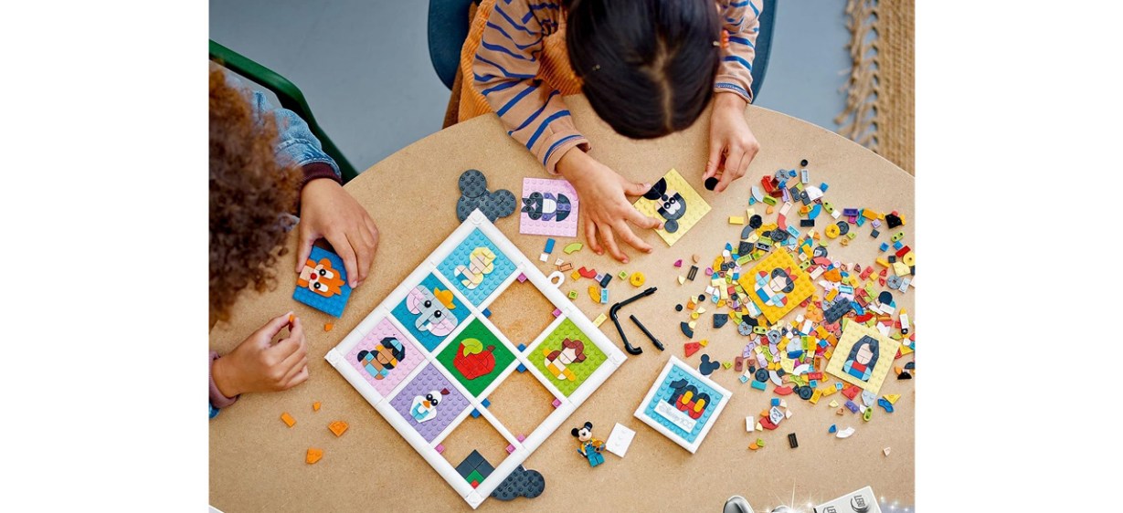 Two kids playing with Lego Disney 100 Years of Disney Animation Icons