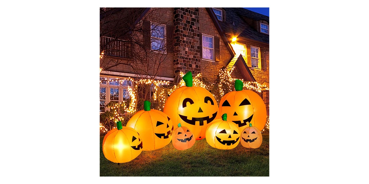 Halloween inflatable pumpkins in front yard at night