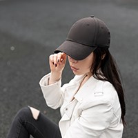 a woman wearing a black baseball cap